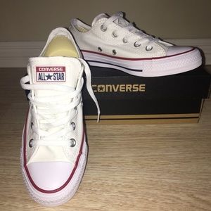 Brand new pair of white converse shoes.